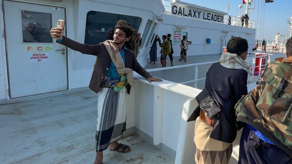 A man takes a selfie on the Galaxy Leader commercial ship, seized by Yemen's Houthis last month, off the coast of al-Salif, Yemen December 5, 2023.