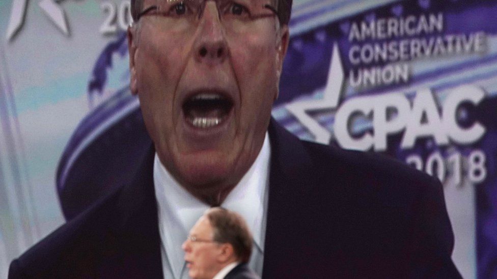 Wayne LaPierre speaks with a giant image of him on screen behind