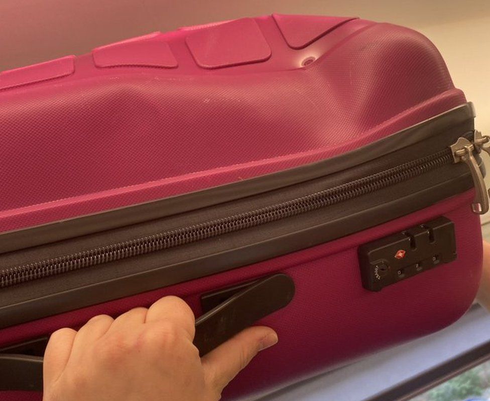 Ellie Foster's dented suitcase