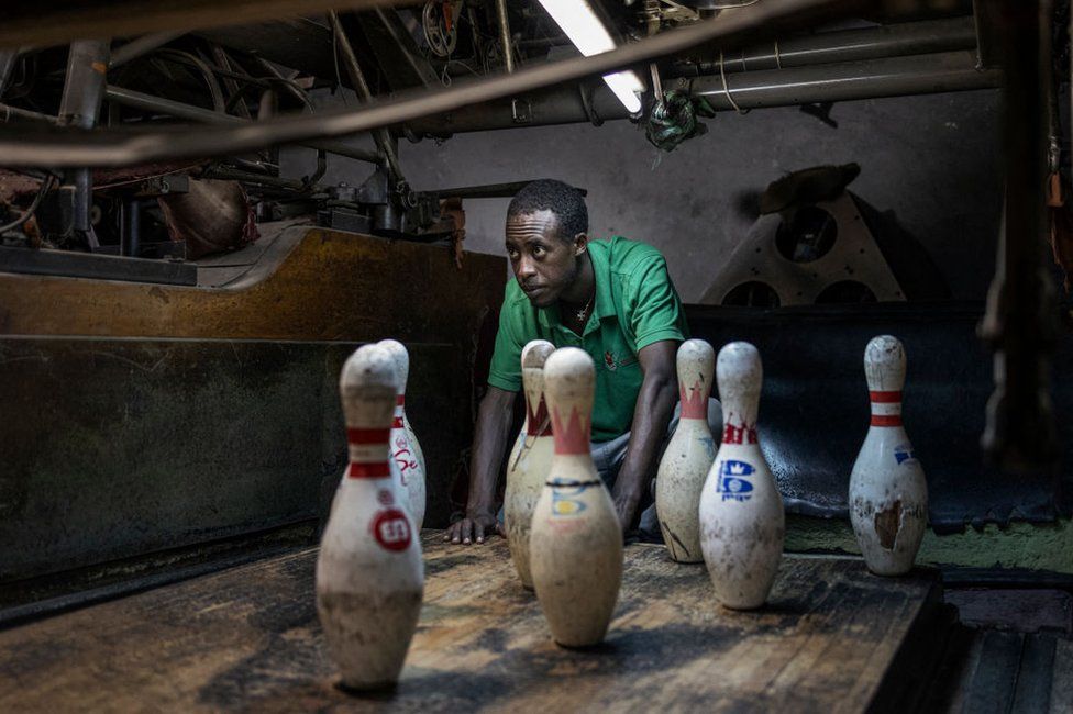 An employee manually resets pins at the Guenet Bowling alley in Addis Ababa.