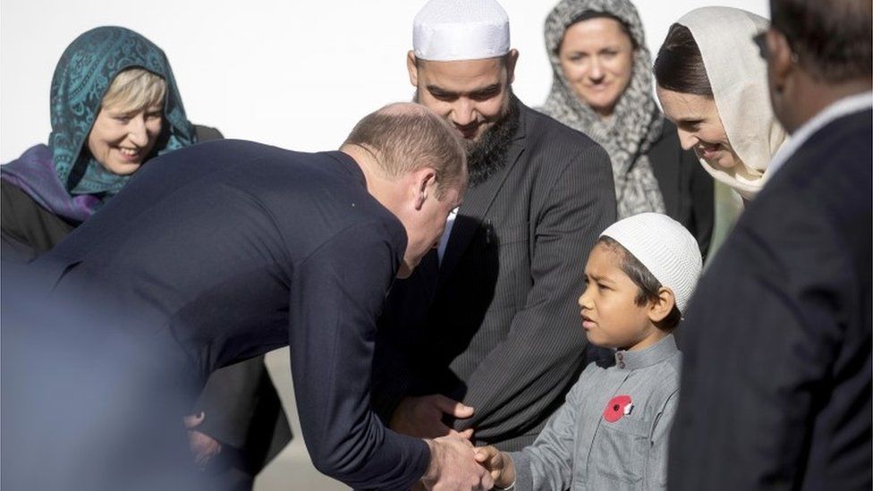 The Duke of Cambridge greets a junior Muslim community member