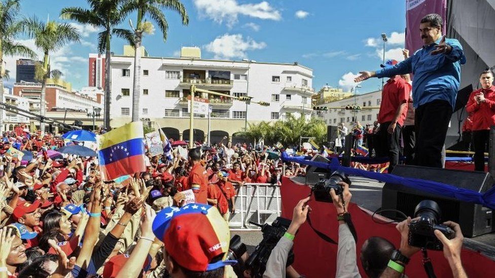 Venezuelan President Nicolas Maduro (R) greets supporters during a rally in Caracas on January 23, 2018.