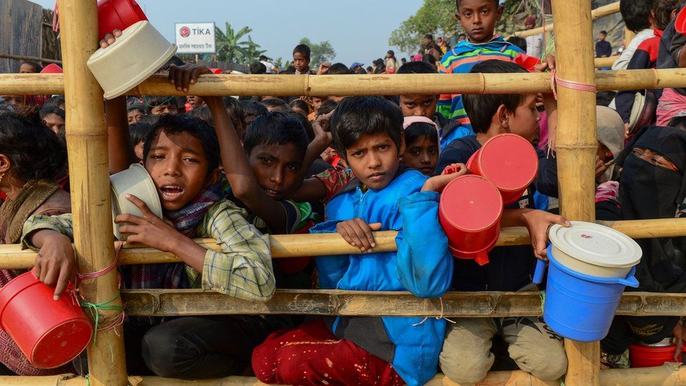 Rohingya Muslim refugees wait for food aid at Thankhali refugee camp in Bangladesh's Ukhia district on 12 January 2018