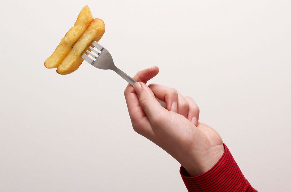 Child with chips on a fork