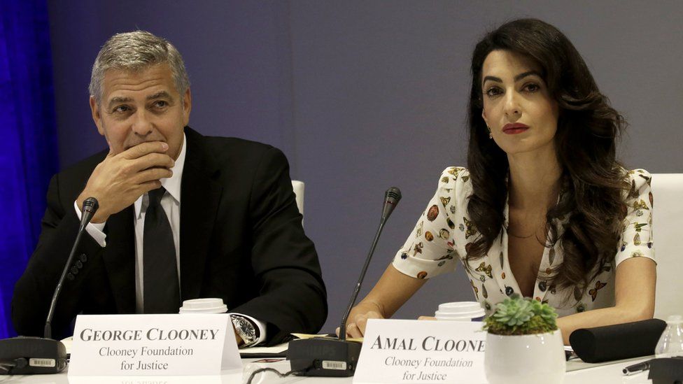 Actor George Clooney (L) and wife Amal Clooney attend a summit at the United Nations General Assembly on September 20, 2016 in New York