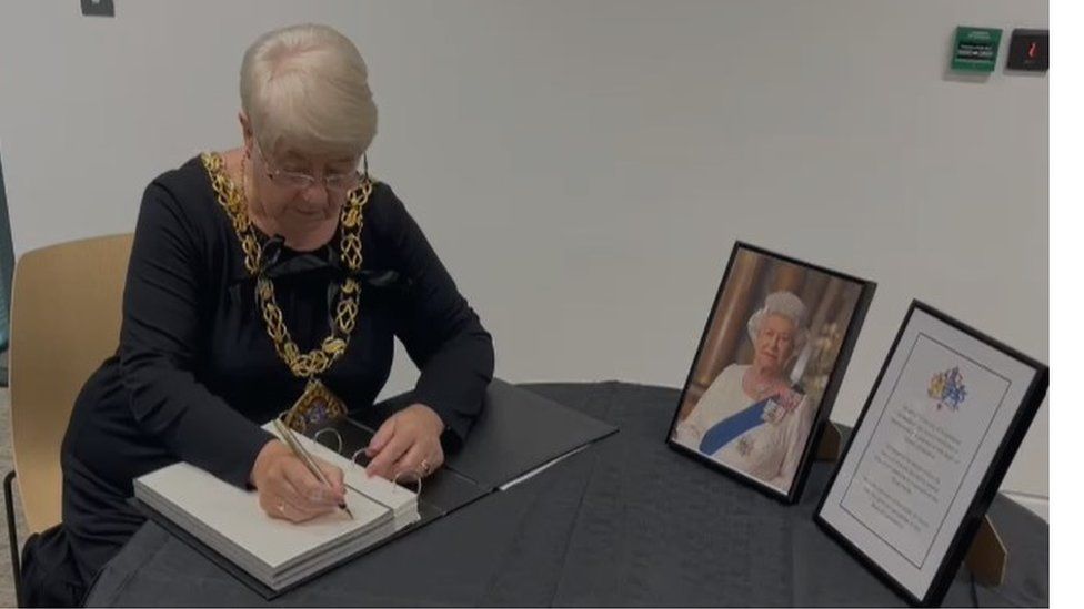Mayor Alison Smith signs book of condolence at City Hall