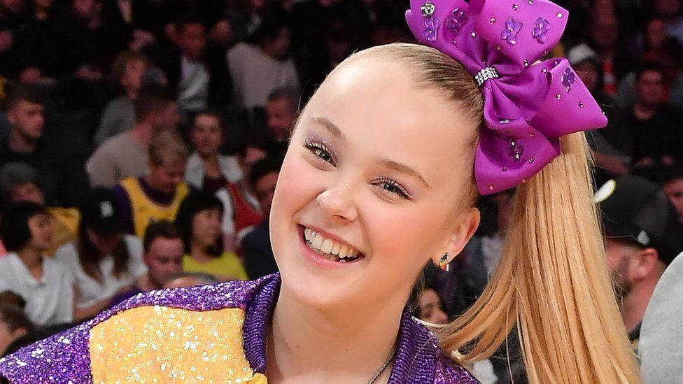 Singer JoJo Siwa throws the ceremonial first pitch of the game