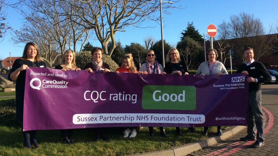 Staff from Sussex Partnership NHS Foundation Trust celebrate their new CQC rating