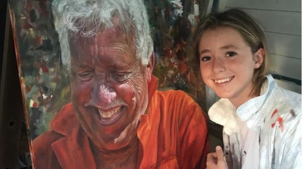Makenzy with the portrait of her grandfather