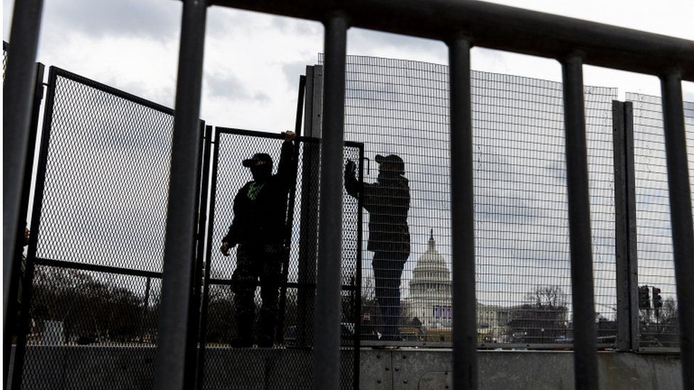 Workers assemble barricades around the US Capitol