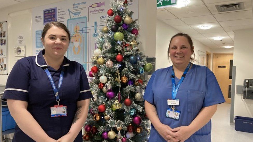Katie Scripps and Sharon Ward posed with a Christmas tree on the neo-natal unit