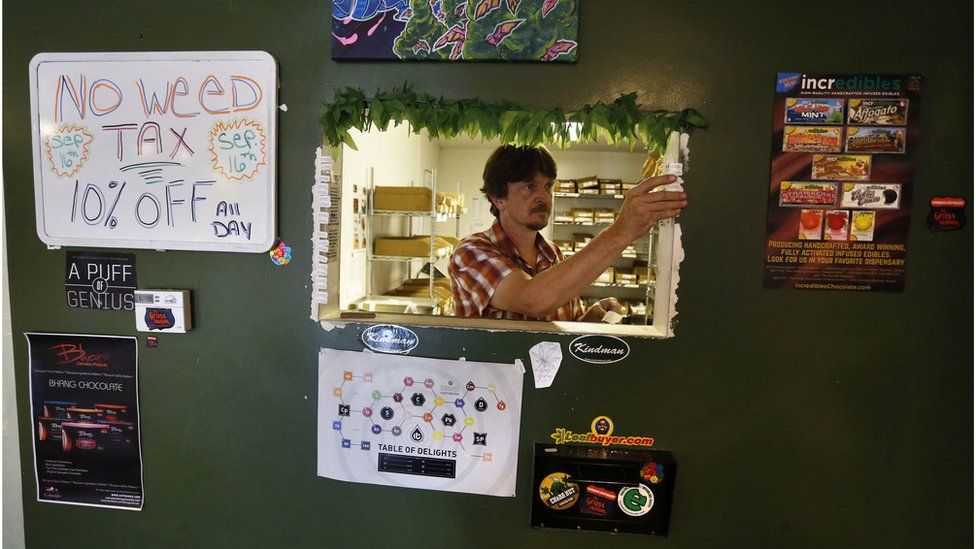 Inventory specialist David Shepard prepares date-of-purchase stickers that are required by law on all items sold, inside The Grass Station recreational marijuana store, in Denver, Colo., Wednesday, Sept. 16, 2015.