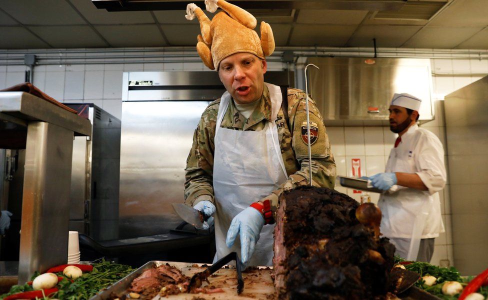 US Army soldier serves Thanksgiving meal to comrades at the Resolute Support headquarters in Kabul, Afghanistan November 22, 2018