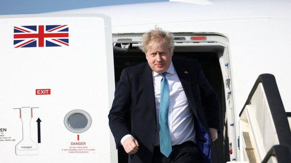 Boris Johnson seen exiting a plane ahead of a Nato summit in Brussels