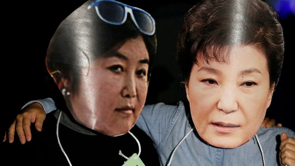 Protesters wearing cut-outs of South Korean President Park Geun-hye (R) and Choi Soon-sil attend a protest - October 27