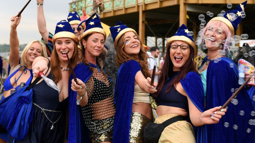 Festival goers in fancy dress enjoy day two of Glastonbury Festival