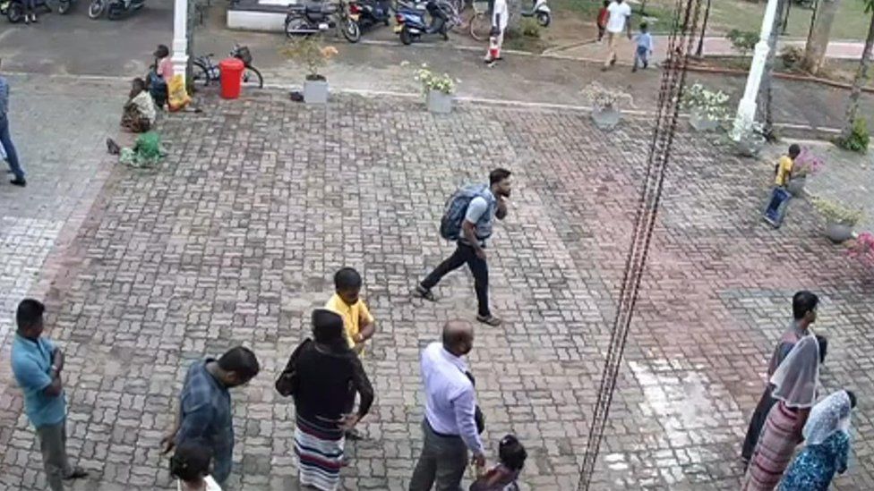 This still image taken from Sri Lankan closed-circuit TV on April 21, 2019, a suspected bomber (C) with backpack on his way to enter St. Sebastian"s Church in Negombo,