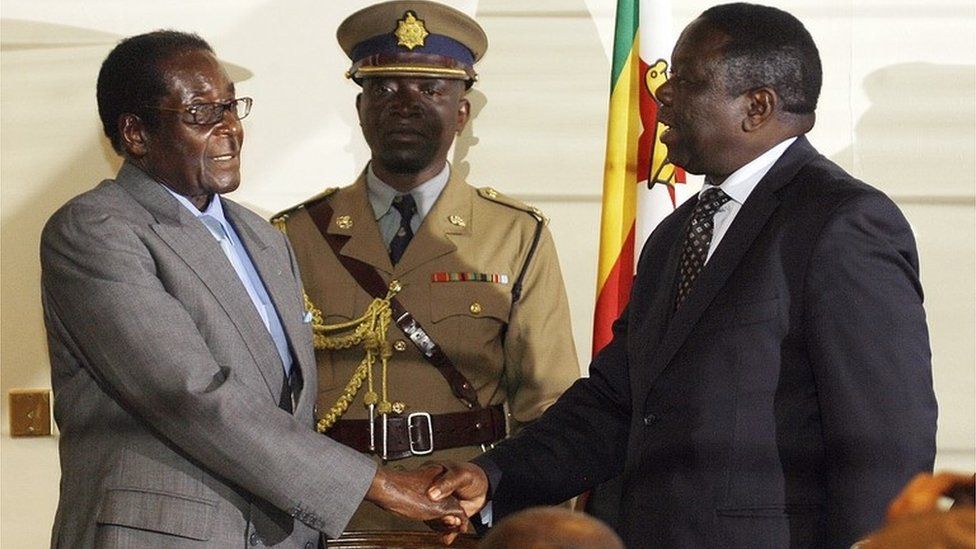 Tsvangirai shakes hands with Mugabe