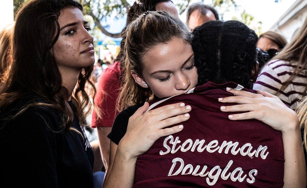 Students from Marjory Stoneman Douglas High School in Parkland, Florida, attend a memorial following a deadly shooting incident, 16 February 2018