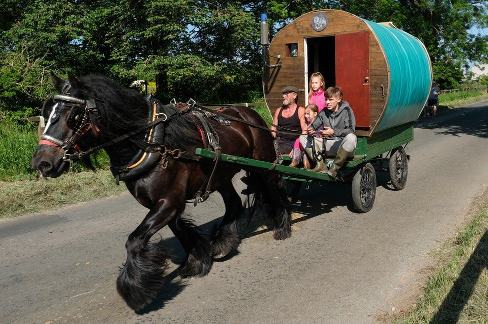 A traditional bow top caravan is driven to the campsite on the first day of the Appleby Horse Fair