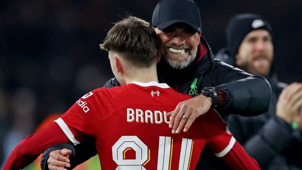 Liverpool manager Jurgen Klopp embraces Conor Bradley after the Carabao Cup semi final second leg match