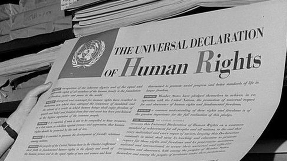 A man looks at one of the first documents published by the United Nations, The Universal Declaration of Human Rights