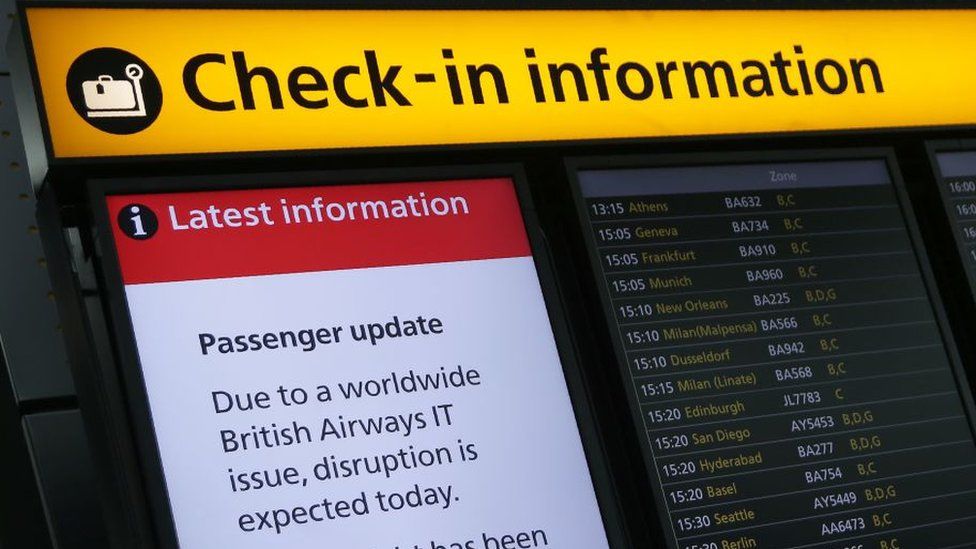 A display warning passengers to 'Expect Disruption' to British Airways flights, is pictured inside Terminal 5 of London's Heathrow Airport