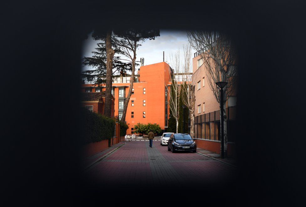 A person walks behind the door of the Monte Hermoso residence for the elderly in Madrid on 17 March, 2020