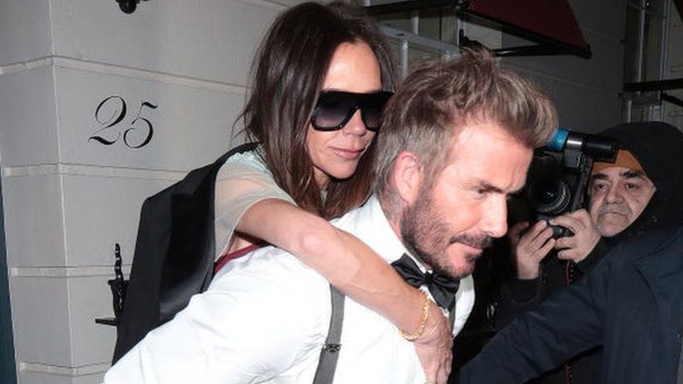 David Beckham carrying Victoria out of the party