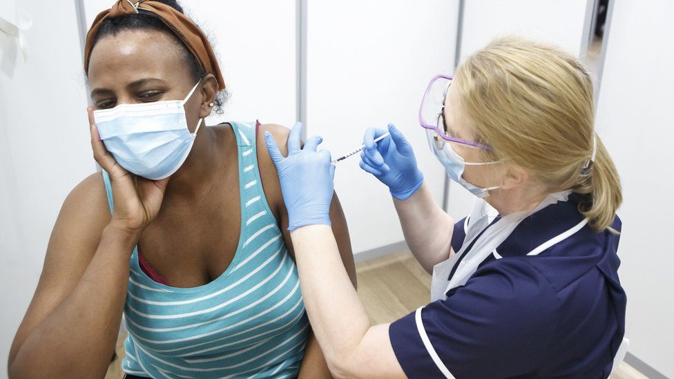 A woman receiving the Pfizer vaccine