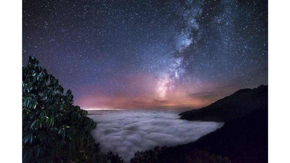 Milky Way above the clouds ocean