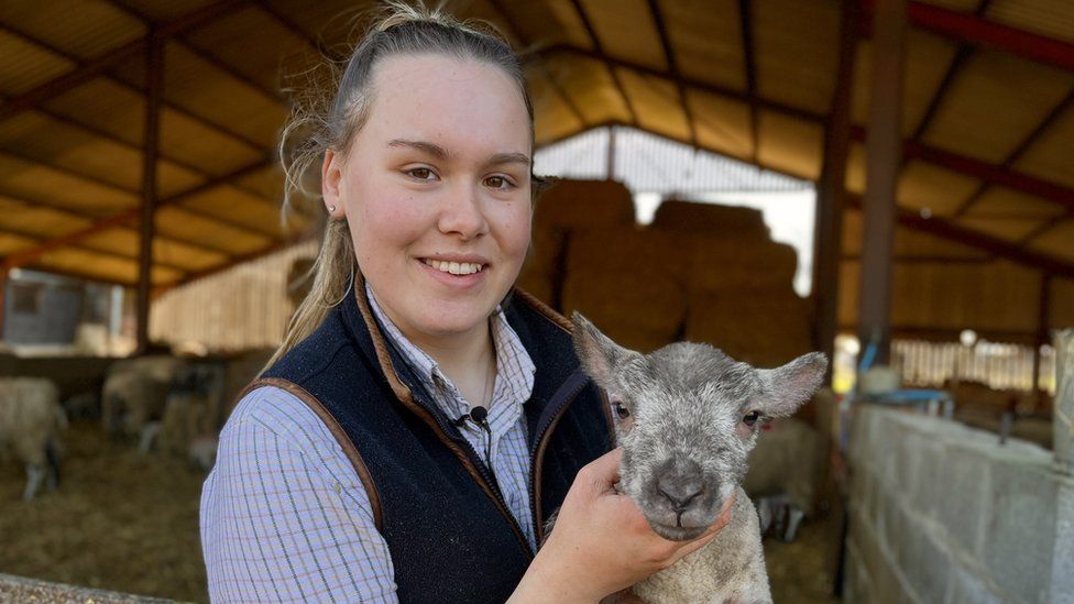 Libby Lawrence with a lamb