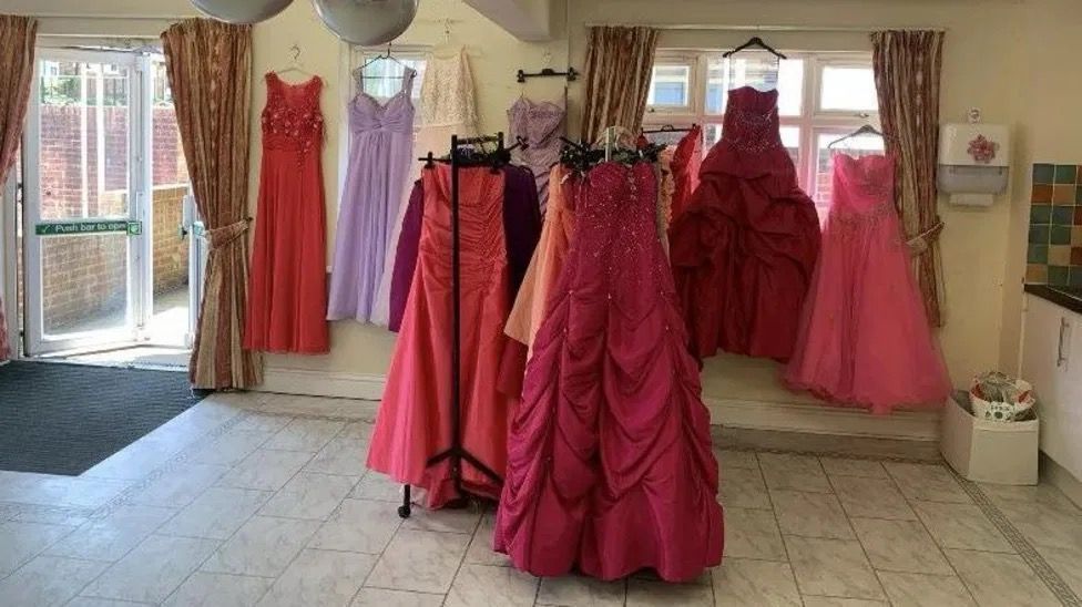 Prom dresses on racks and hanging up