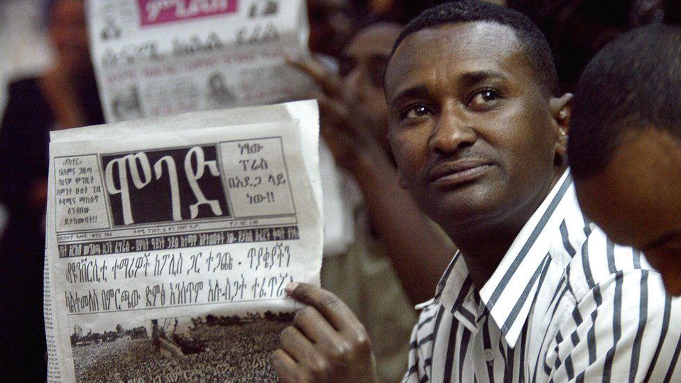Man reads a newspaper in Addis Ababa