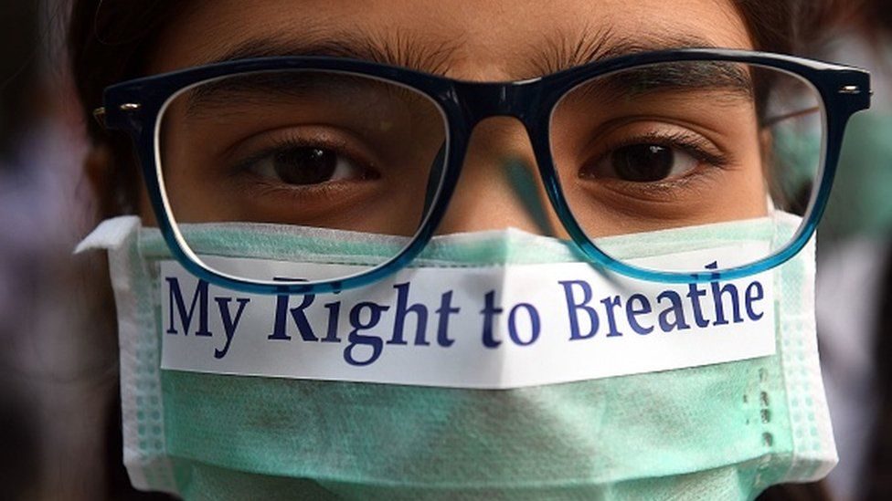 An Indian youth wearing a pollution mask participates in a march to raise awareness of air pollution levels in New Delhi on November 15, 2017.