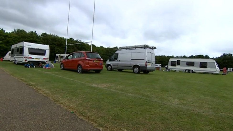 Caravans and cars in a field
