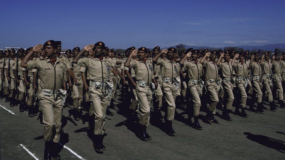 Ceremonial troops saluting during Pakistan National Day military parad