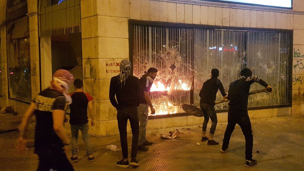 Protesters attack a building in the Lebanese city of Tripoli on 27 April 2020