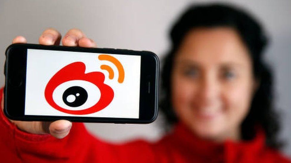 Chinese micro blogging social network is displayed on an iPhone. The company is about to list on Hong Kong's main exchange