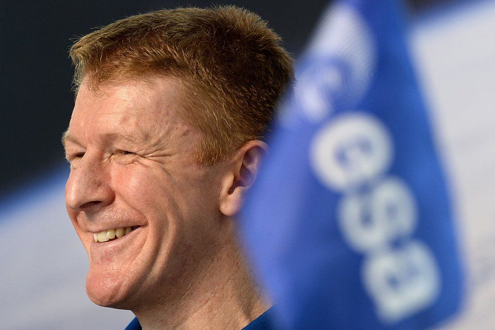 British astronaut Tim Peake with a European Space Agency flag