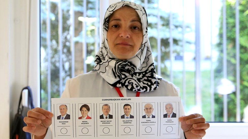 A returning officer shows a voting paper for the Presidential and General elections in Turkey, at a polling station at Turkey Consulate-General in Berlin on June 07