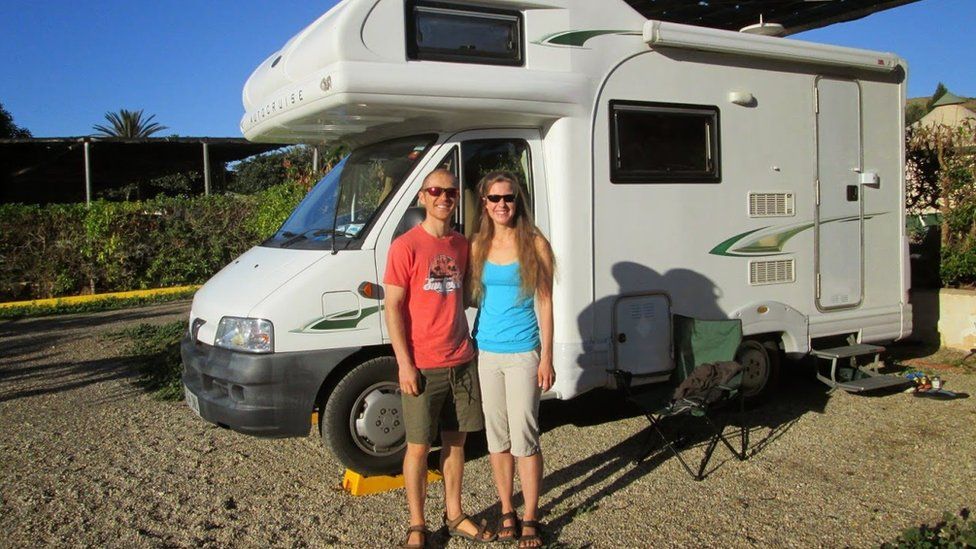 Dan and Esther in front of their campervan