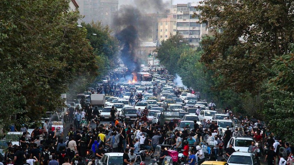 Protesters block a street in Tehran