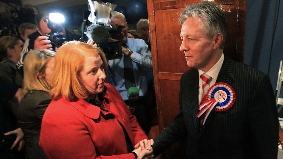 Then-first minister Peter Robinson shakes hands with Naomi Long after losing his east Belfast seat to her in 2010
