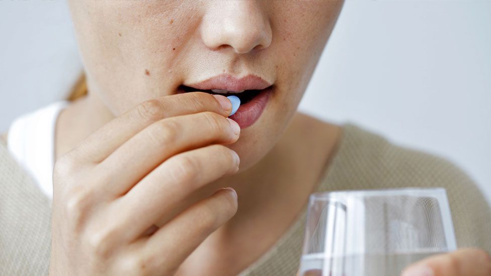 Woman taking a pill