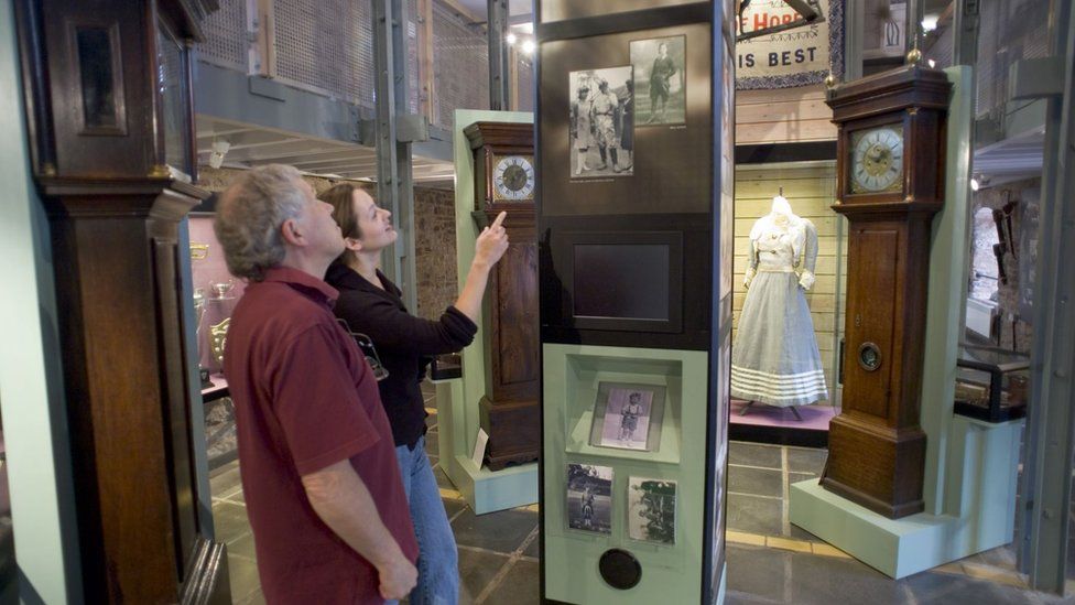 People observing an exhibit at the Dean Heritage Centre