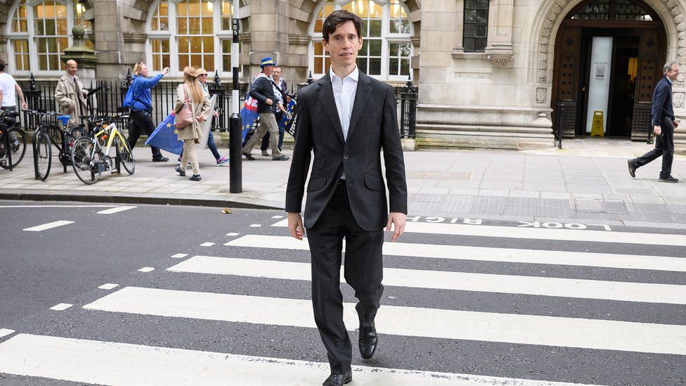 Rory Stewart walks on a pedestrian crossing as he heads to the House of Commons