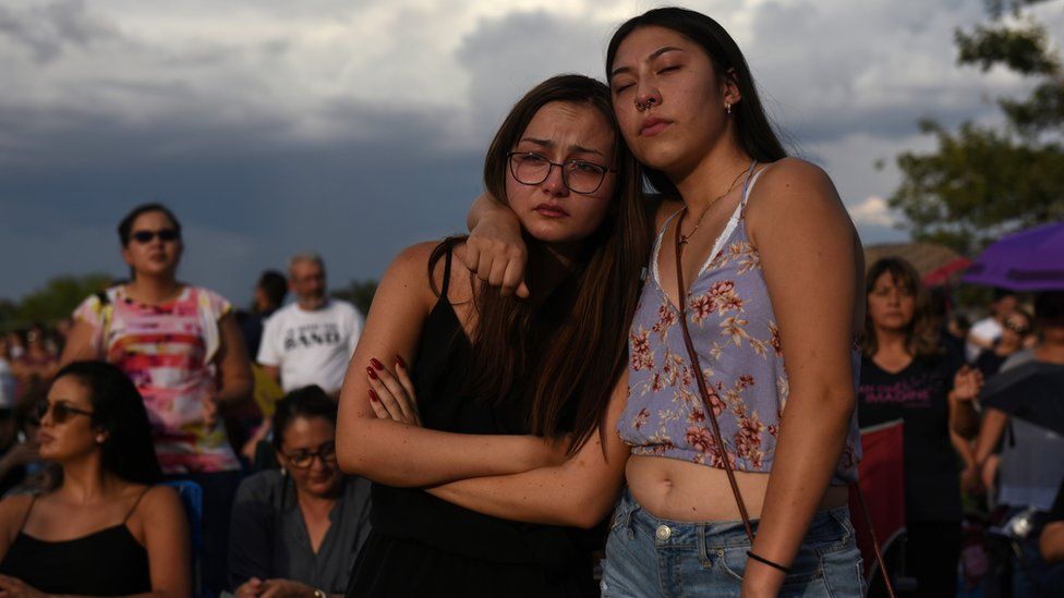 Amber Ruiz and Jazmyn Blake embrace during a vigil a day after a mass shooting at a Walmart store in El Paso