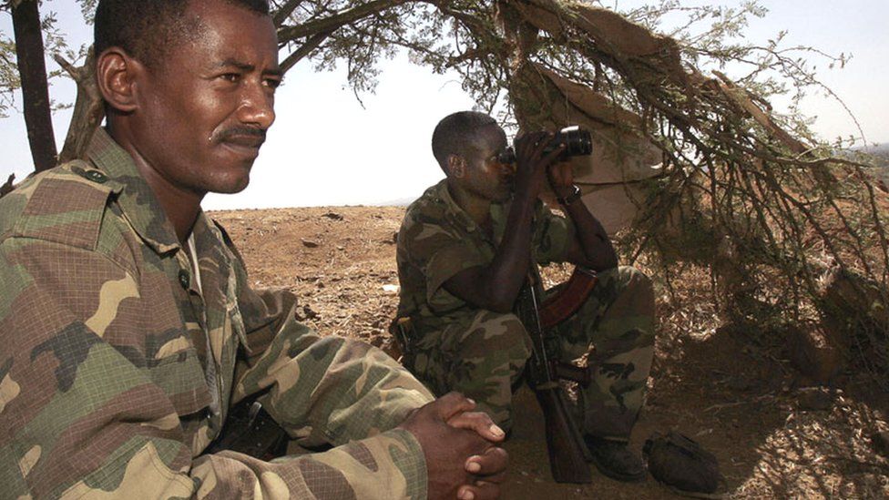 Ethiopian soldiers take advantage of the shade of a tree on 20 November 2005 on a hilltop outpost overlooking the northern Ethiopian town of Badme, in the Tigray region, towards the Temporary Security Zone and the Eritrean border.