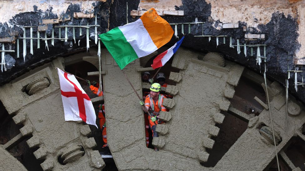 HS2 workers wave flags on the cutter head of the tunnel-boring machine Cecilia breaking through on the Chiltern Tunnel